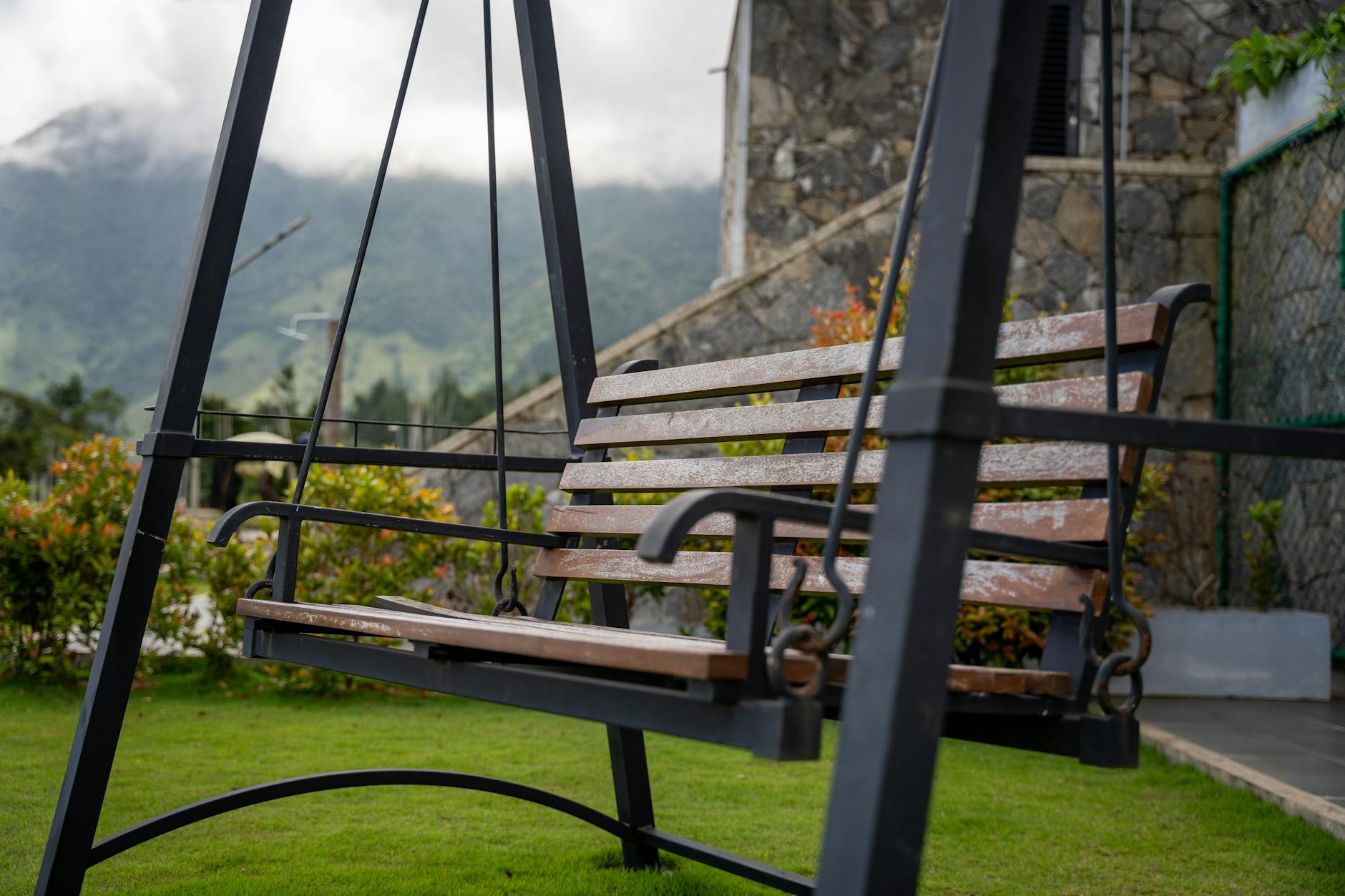 Drewniana huśtawka ogrodowa z widokiem na góry