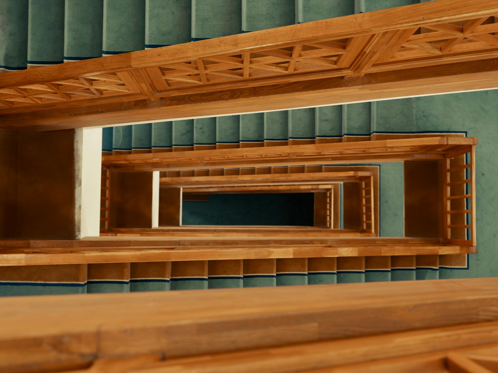 Schody w domu drewnianym: jakie drewno, jaka konstrukcja i jak uniknąć skrzypienia Drewniane schody z turkusową wykładziną widziane z góry